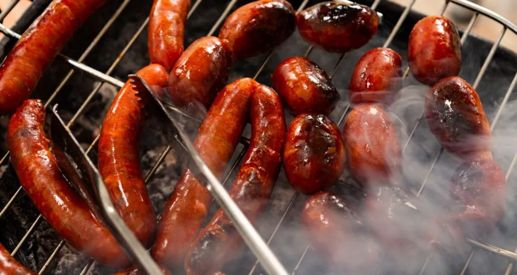 Close-up of grilled kielbasa sausage with herbs and spices